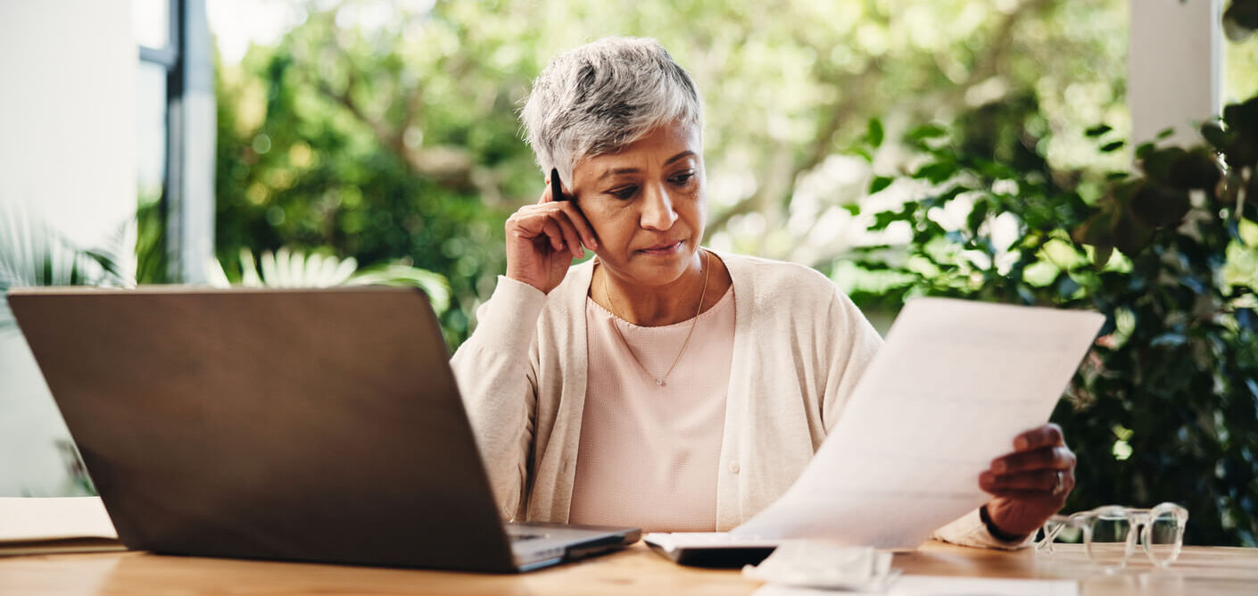 older woman looking at insurance documents and paperwork